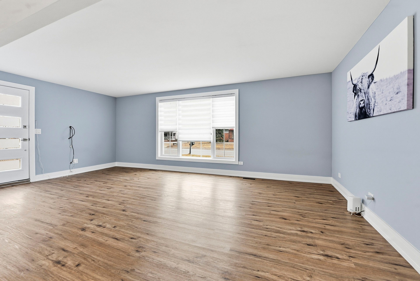 7303 West 75th Street Bridgeview, IL 60455 - Photo 10 of 48 a view of empty room with wooden floor and fan