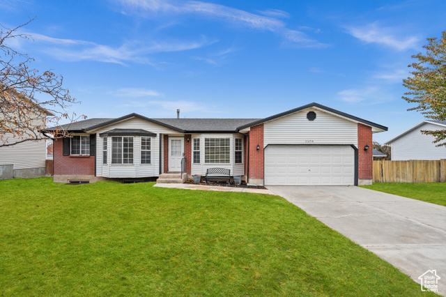 11254 South Silver Ridge Drive Sandy, UT 84094 - Photo 1 of 1 Ranch-style home featuring a garage and a front lawn