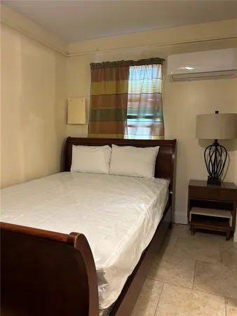 a bedroom with a bed and window