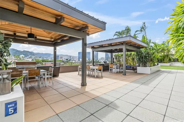 a view of a patio with a table and chairs under an umbrella