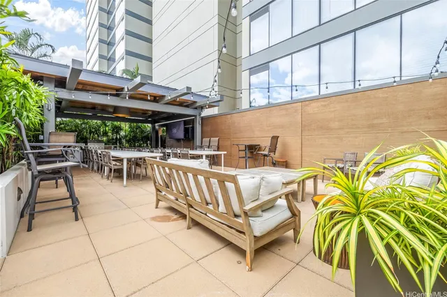a view of a patio with a table and chairs and potted plants