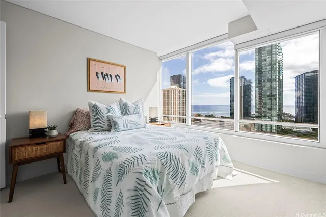 a bedroom with a large bed and a large window