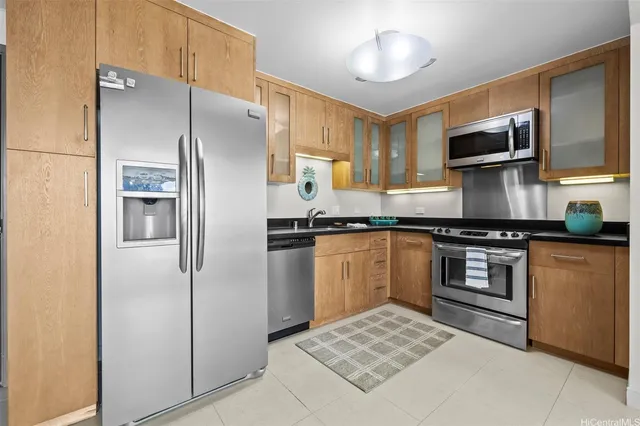 a kitchen with stainless steel appliances granite countertop a refrigerator stove and sink