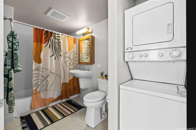a bathroom with a toilet and a shower curtain