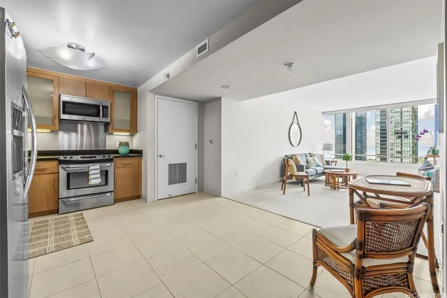 a kitchen with granite countertop a refrigerator and a stove top oven