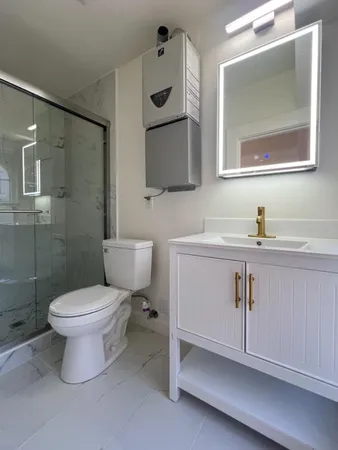 a bathroom with a toilet sink and mirror