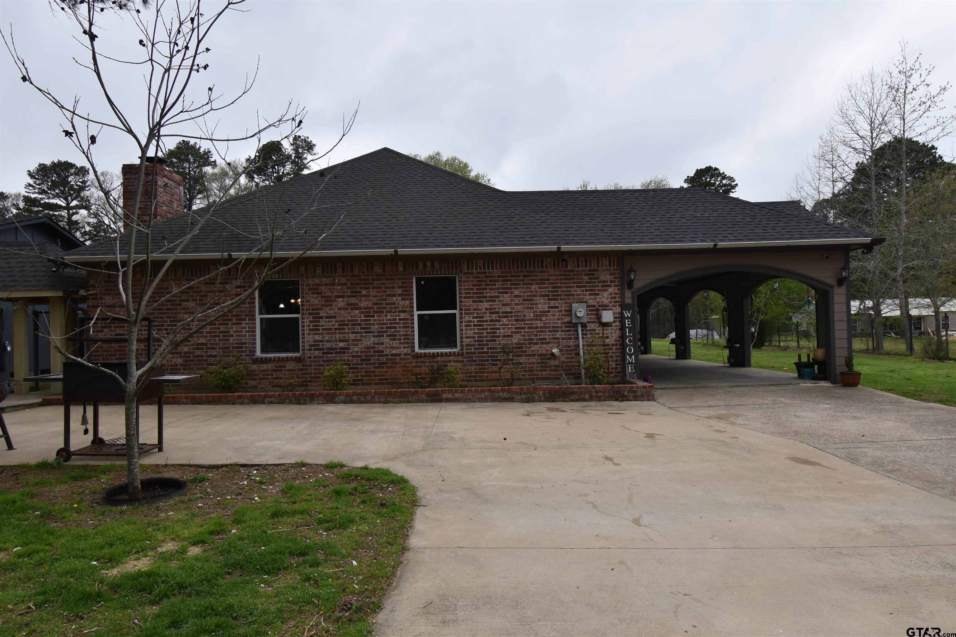 7727 Knowles Trace Tyler, TX 75708 - Photo 1 of 34 a front view of a house with garden