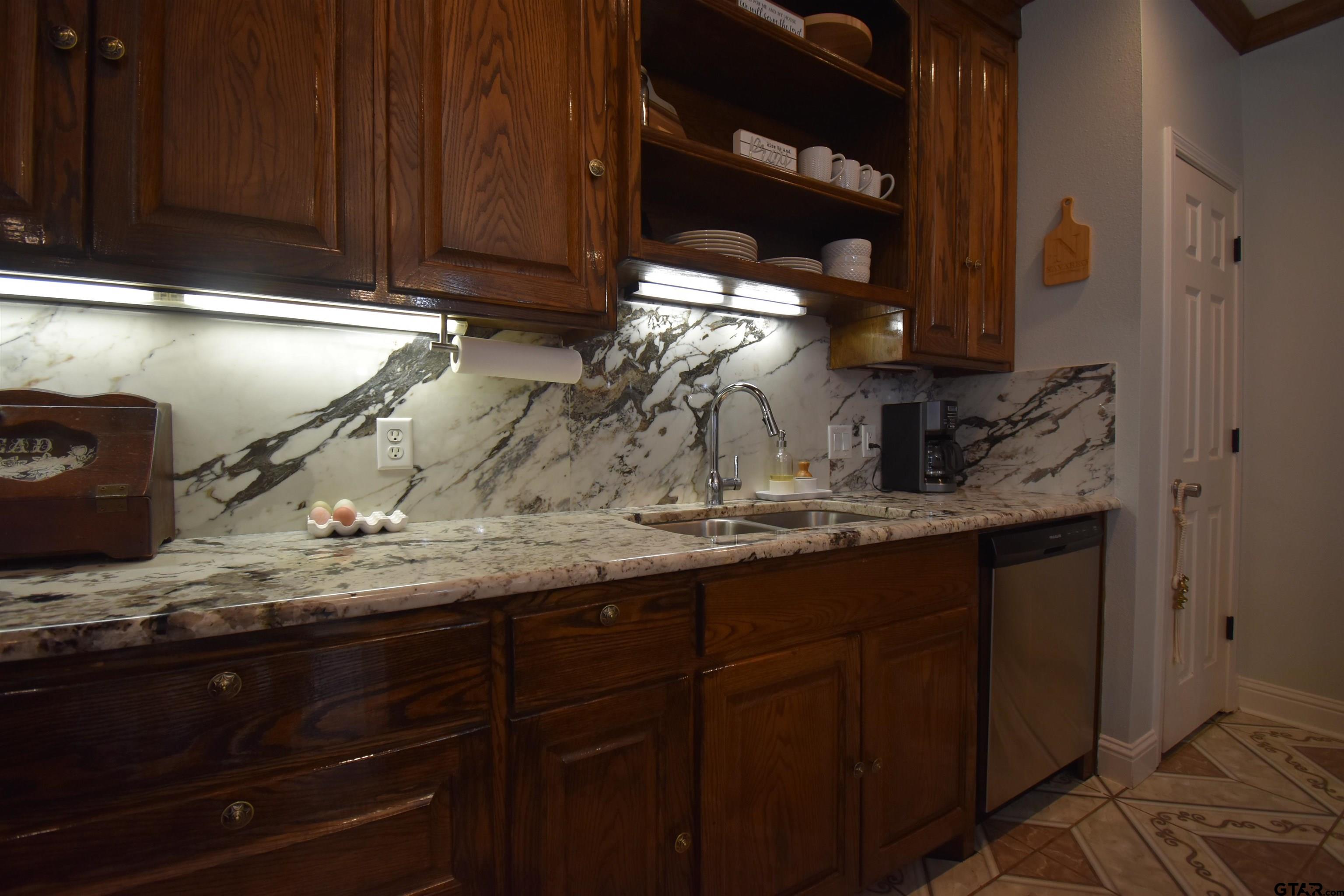 7727 Knowles Trace Tyler, TX 75708 - Photo 17 of 34 a kitchen with a sink and cabinets