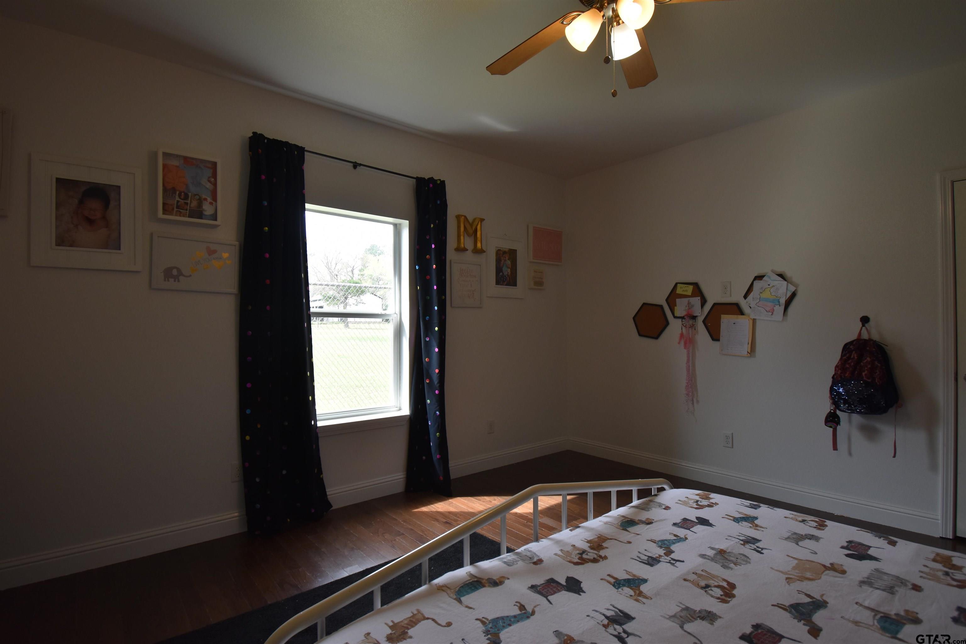 7727 Knowles Trace Tyler, TX 75708 - Photo 24 of 34 a bedroom with a bed and a window