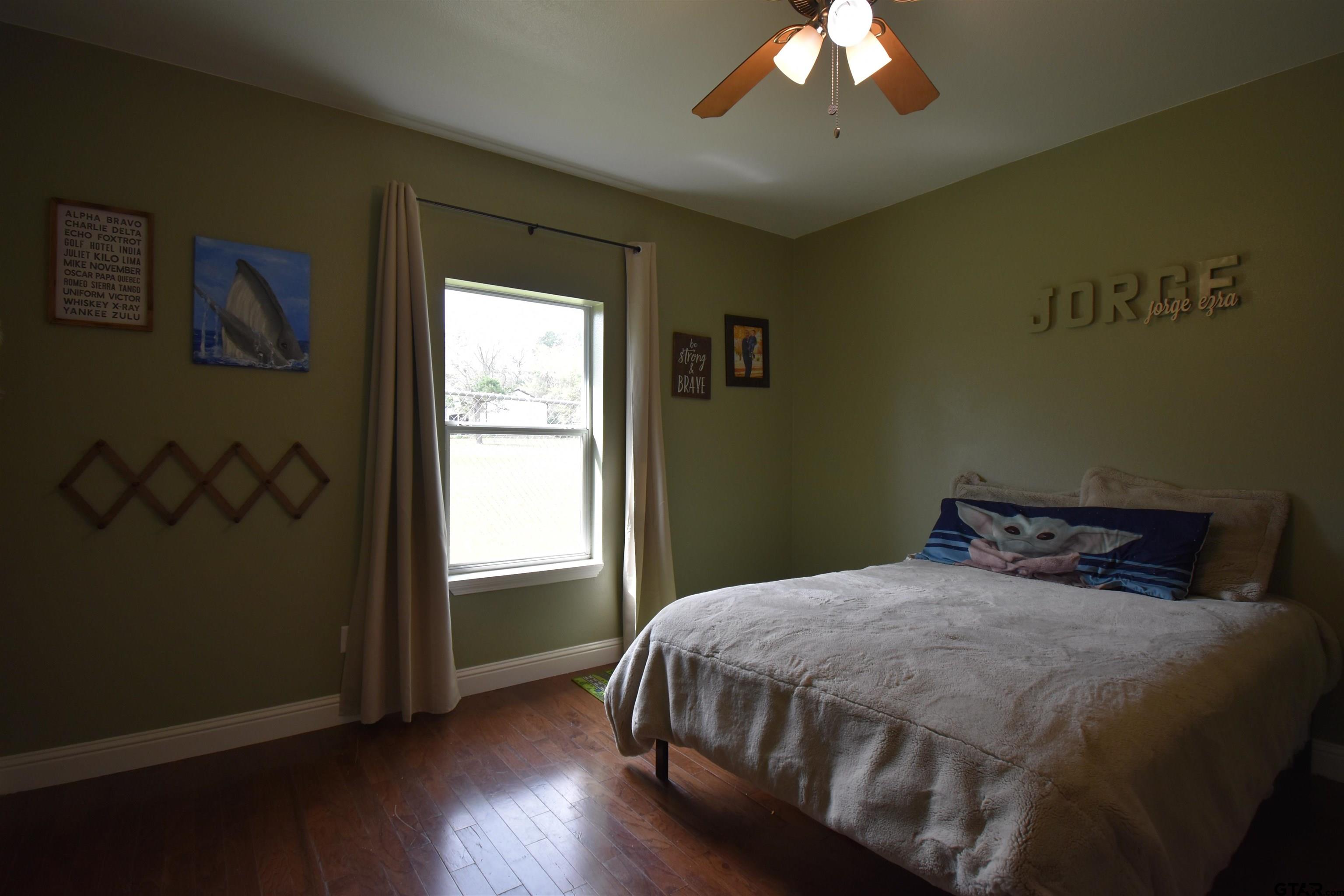 7727 Knowles Trace Tyler, TX 75708 - Photo 26 of 34 a bedroom with a bed and a window