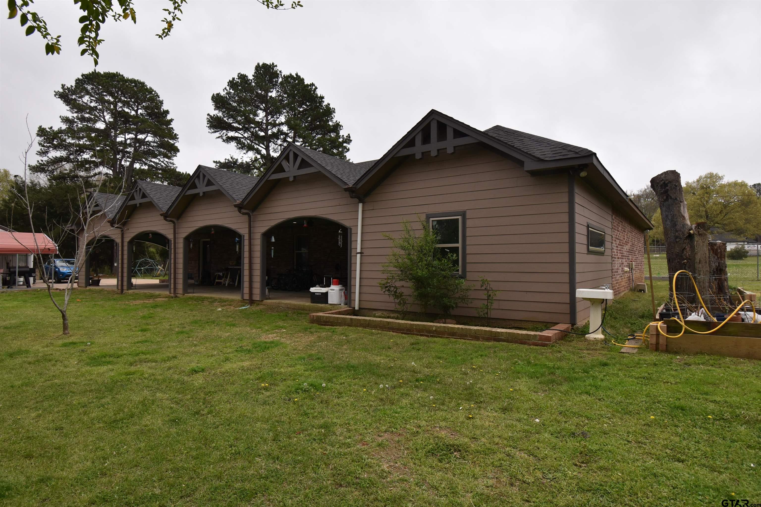 7727 Knowles Trace Tyler, TX 75708 - Photo 29 of 34 a view of a house with backyard and garden