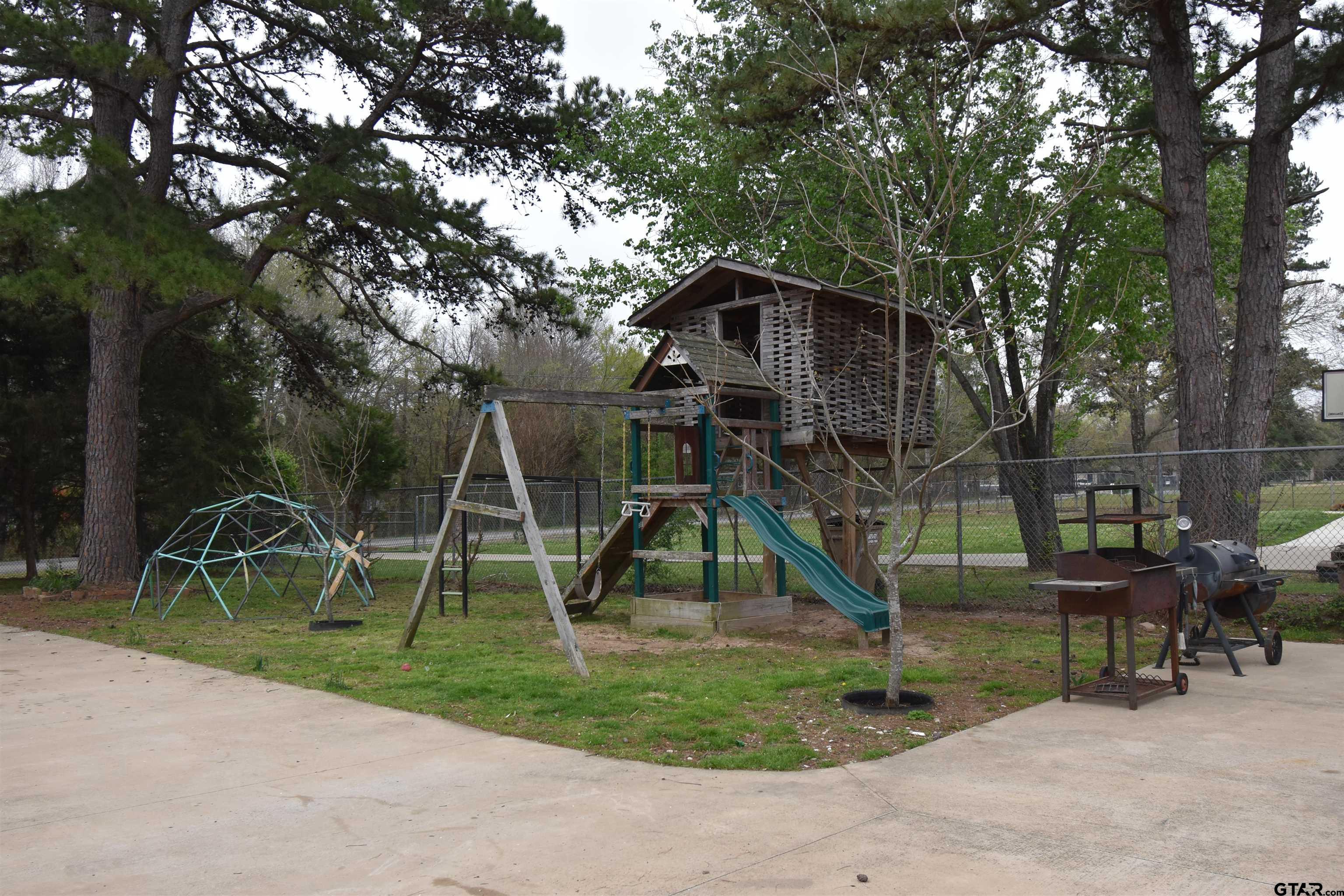 7727 Knowles Trace Tyler, TX 75708 - Photo 30 of 34 a view of playground with a slide and a slide