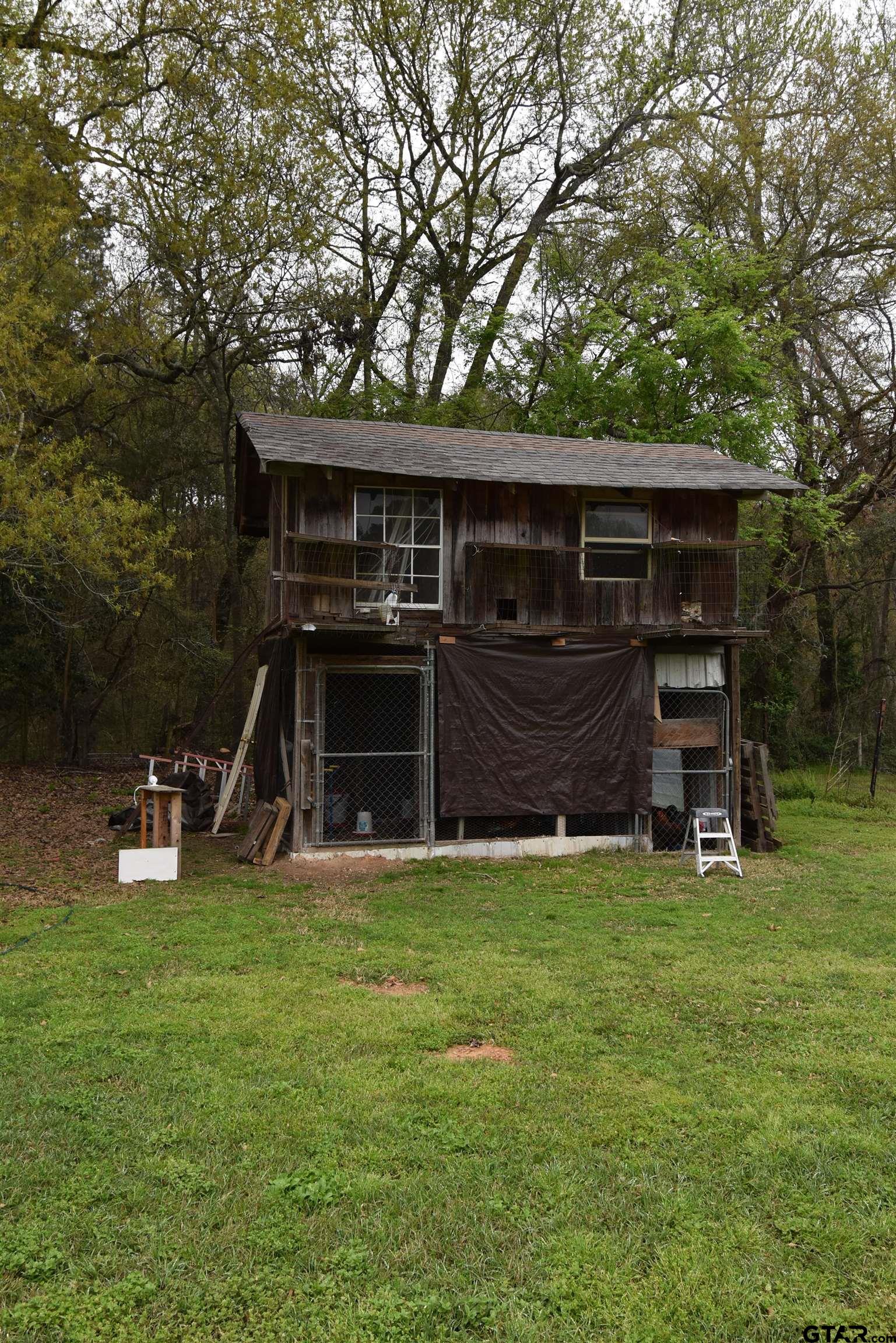 7727 Knowles Trace Tyler, TX 75708 - Photo 31 of 34 a view of a house with backyard and a tree