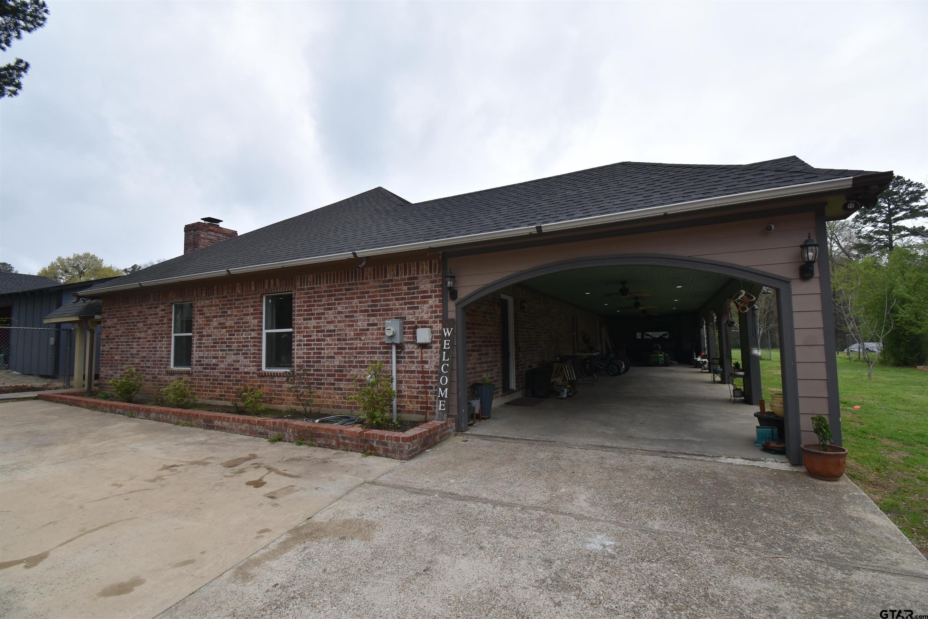 7727 Knowles Trace Tyler, TX 75708 - Photo 5 of 34 a front view of a house with a yard