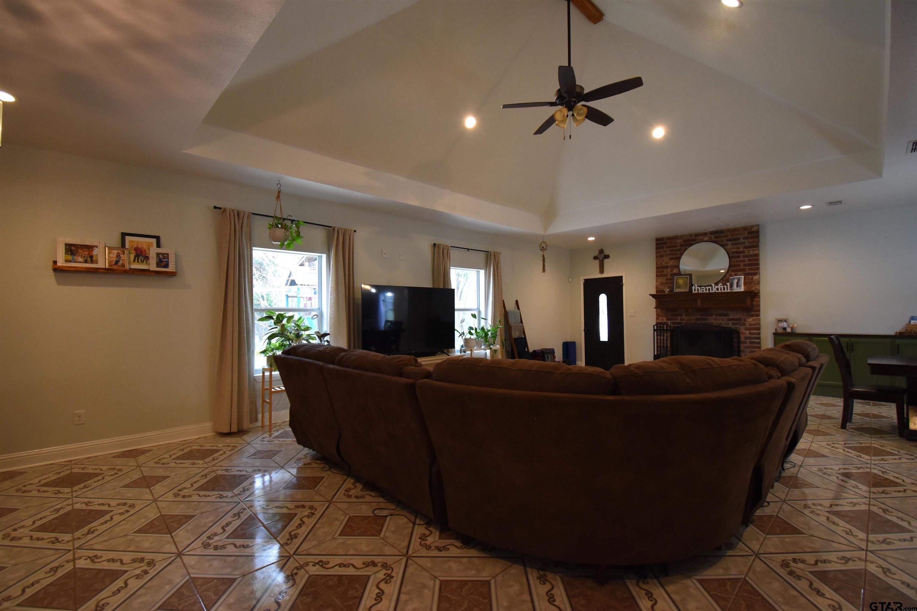 7727 Knowles Trace Tyler, TX 75708 - Photo 6 of 34 a living room with furniture and a flat screen tv