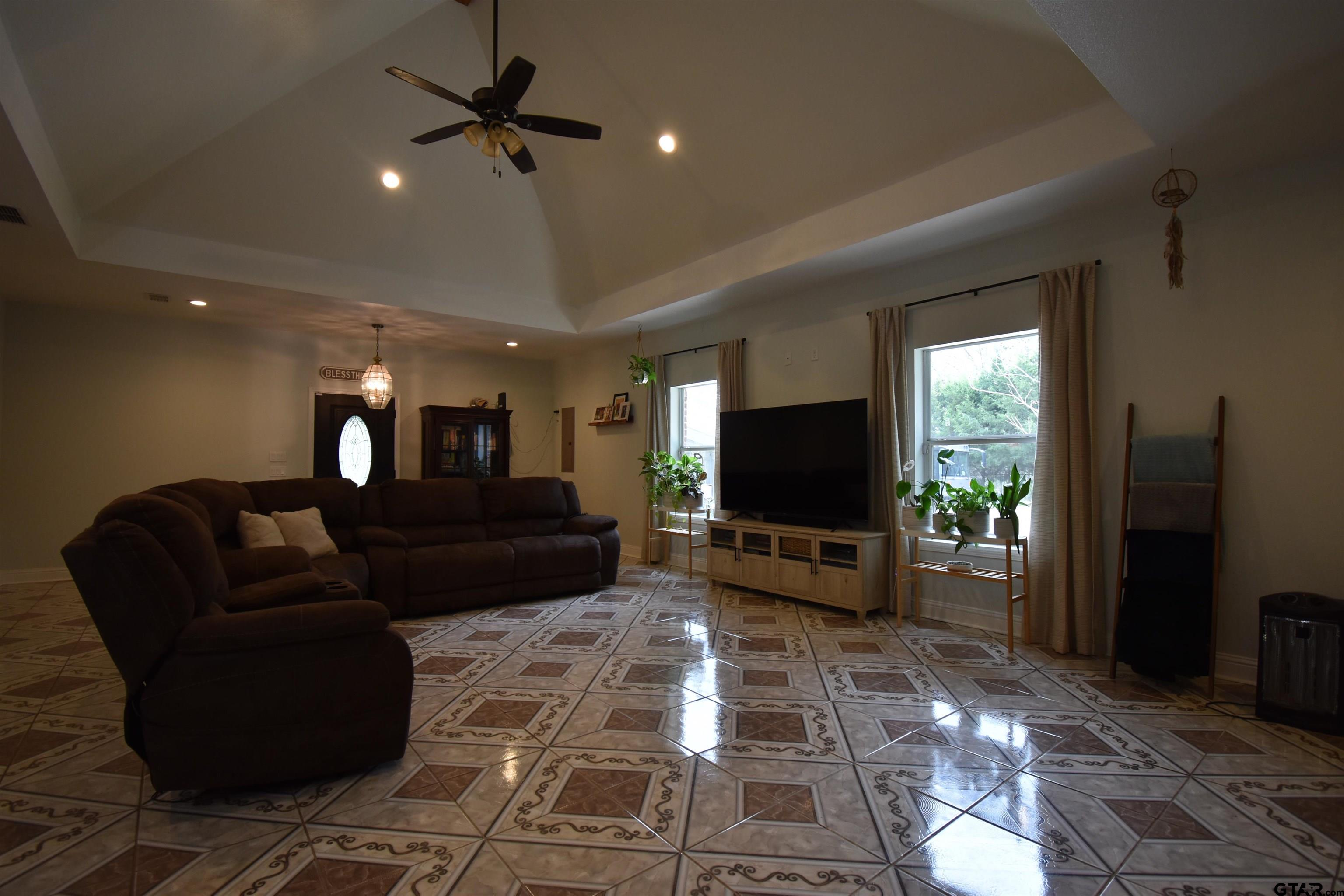 7727 Knowles Trace Tyler, TX 75708 - Photo 7 of 34 a living room with furniture and a flat screen tv