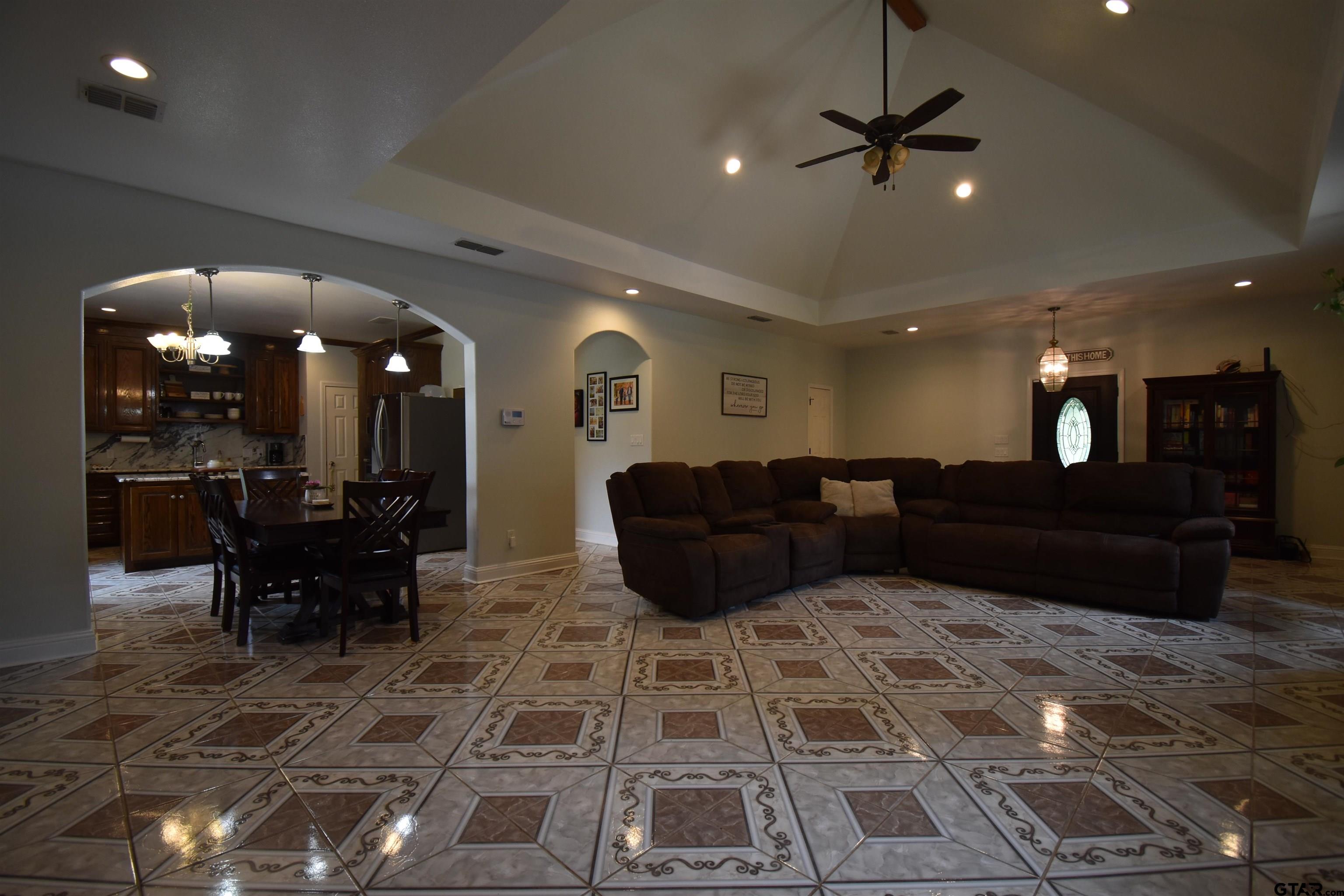 7727 Knowles Trace Tyler, TX 75708 - Photo 8 of 34 a living room with lots of furniture and a chandelier