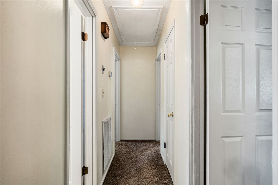 312 Edwards Drive Anderson, SC 29626 - Photo 14 of 44 A well-lit corridor with clean white doors and a plush carpet welcomes residents and guests alike.