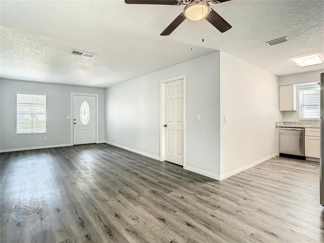 a view of an empty room and wooden floor