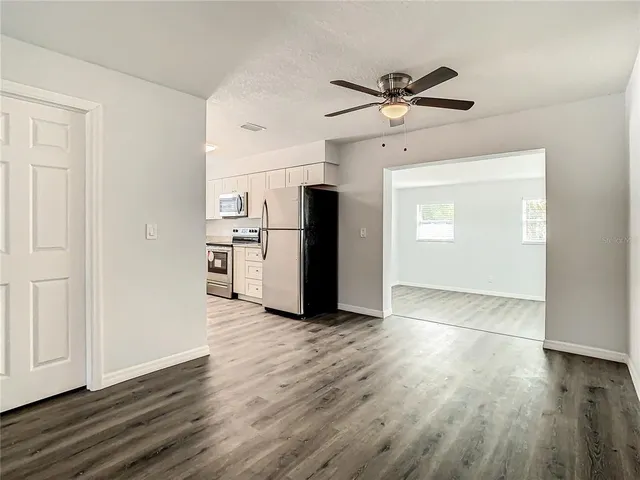 a kitchen with white cabinets and white appliances