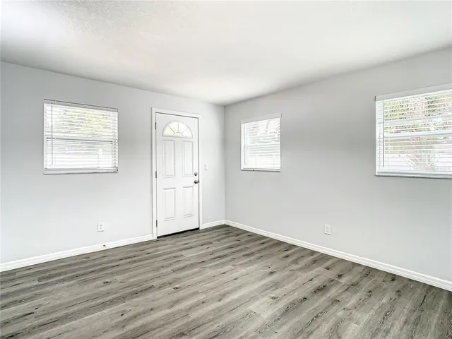 a view of a room with wooden floor