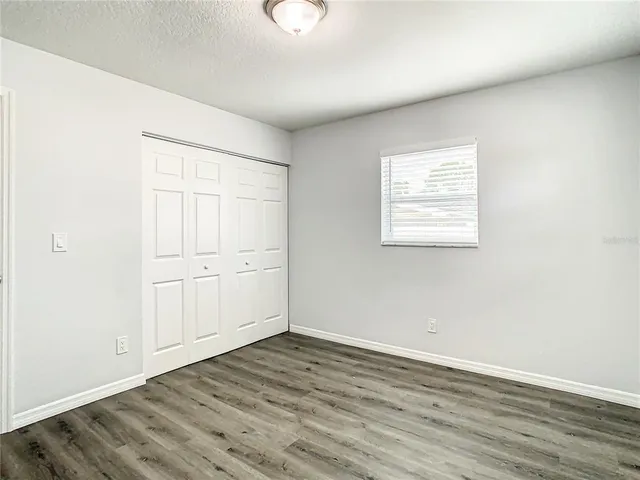 an empty room with wooden floor