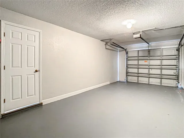 a view of a house with a yard and potted plants