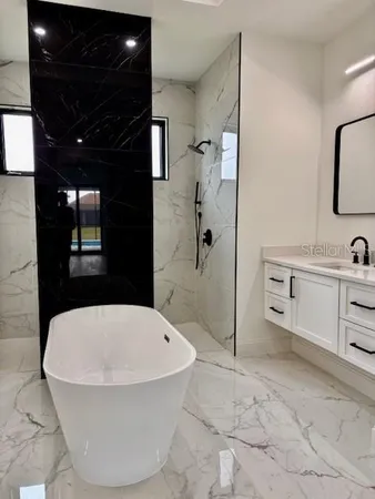a bathroom with a tub and sink