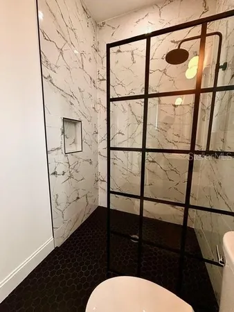 a bathroom with a toilet a sink and a shower