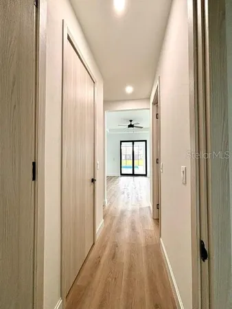 a view of a hallway with wooden floor
