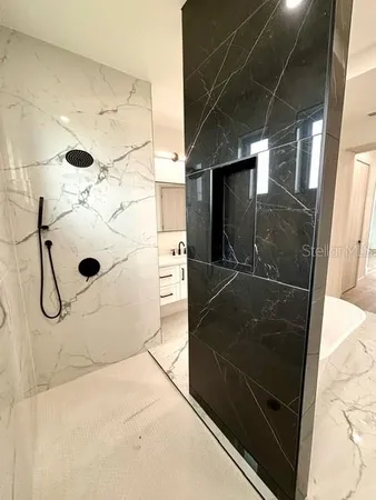 a bathroom with a glass shower door