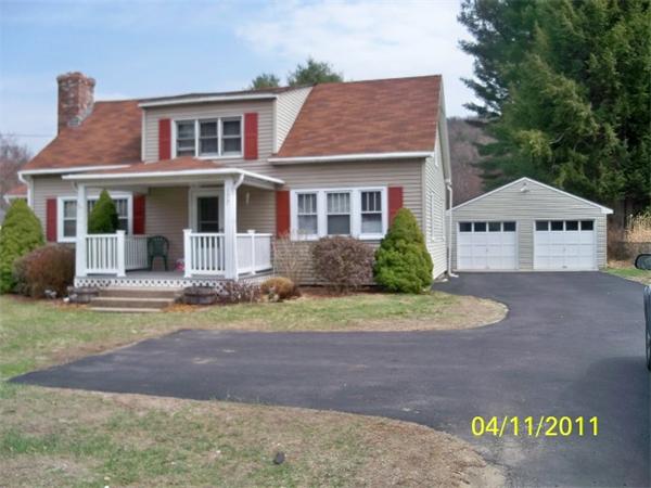 177 Palmer Road Monson, MA 01057 - Photo 1 of 28 a front view of a house with a yard and garage