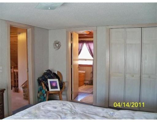177 Palmer Road Monson, MA 01057 - Photo 23 of 28 a bedroom with a bed and a mirror