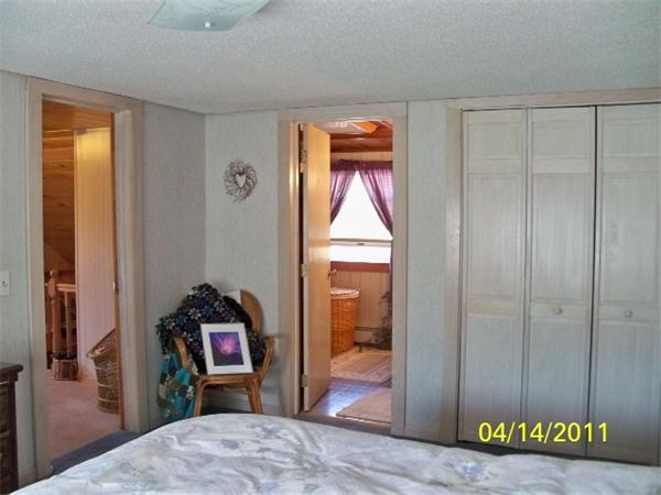 177 Palmer Road Monson, MA 01057 - Photo 24 of 28 a bedroom with a bed and a mirror
