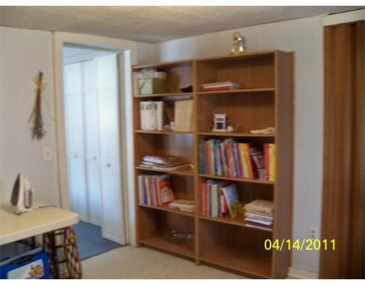 177 Palmer Road Monson, MA 01057 - Photo 25 of 28 a shelf with books and knick knacks on it