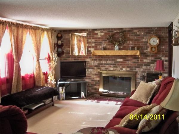 177 Palmer Road Monson, MA 01057 - Photo 9 of 28 a living room with furniture a flat screen tv and a fireplace