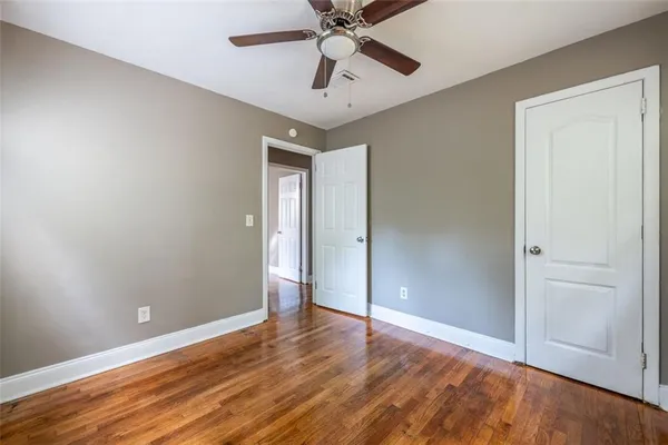a view of room with hardwood floor and ceiling fan