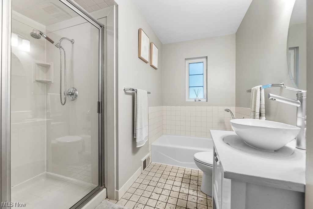 32261 Cedar Road Cleveland, OH 44124 - Photo 21 of 35 Full bathroom featuring separate shower and tub, mirror, large vanity, and light tile floors