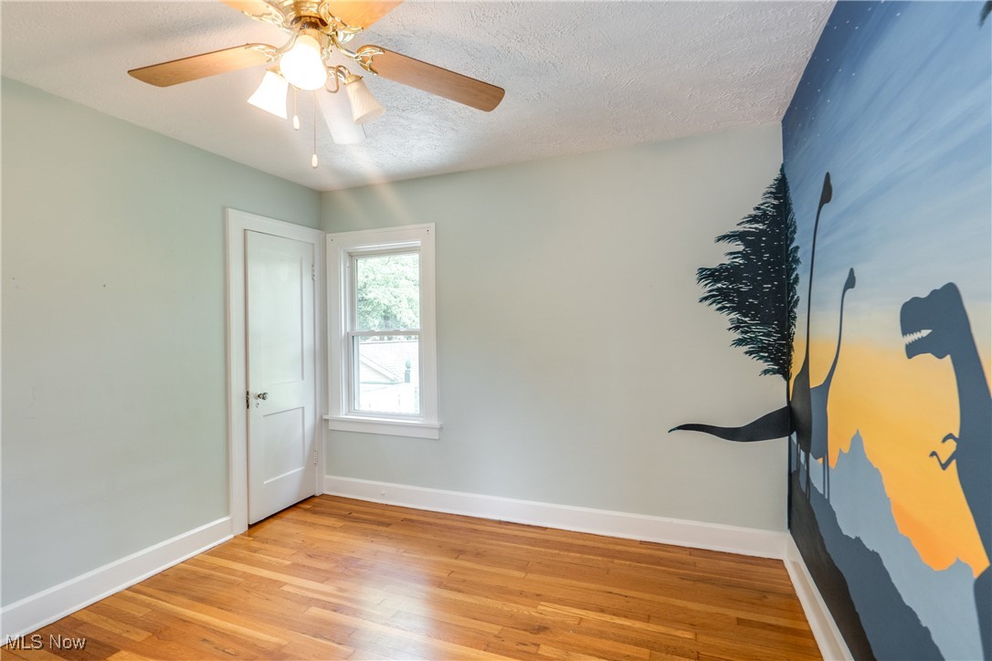 3130 Corydon Road Cleveland, OH 44118 - Photo 22 of 44 Unfurnished room with light hardwood / wood-style floors, a textured ceiling, and ceiling fan