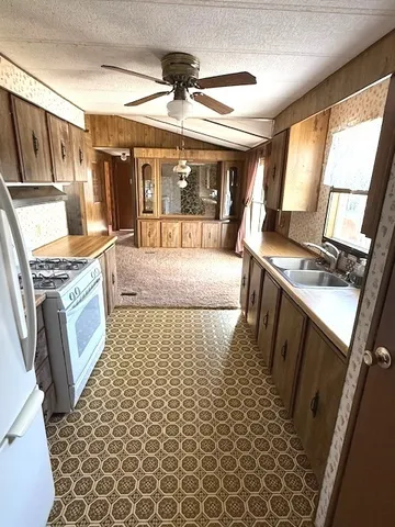 a bathroom with a granite countertop sink a large mirror and a shower