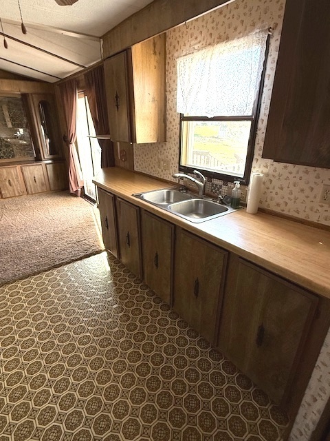136 North Washington Street Sheffield, IL 61361 - Photo 9 of 17 a kitchen with granite countertop a sink a stove and a refrigerator