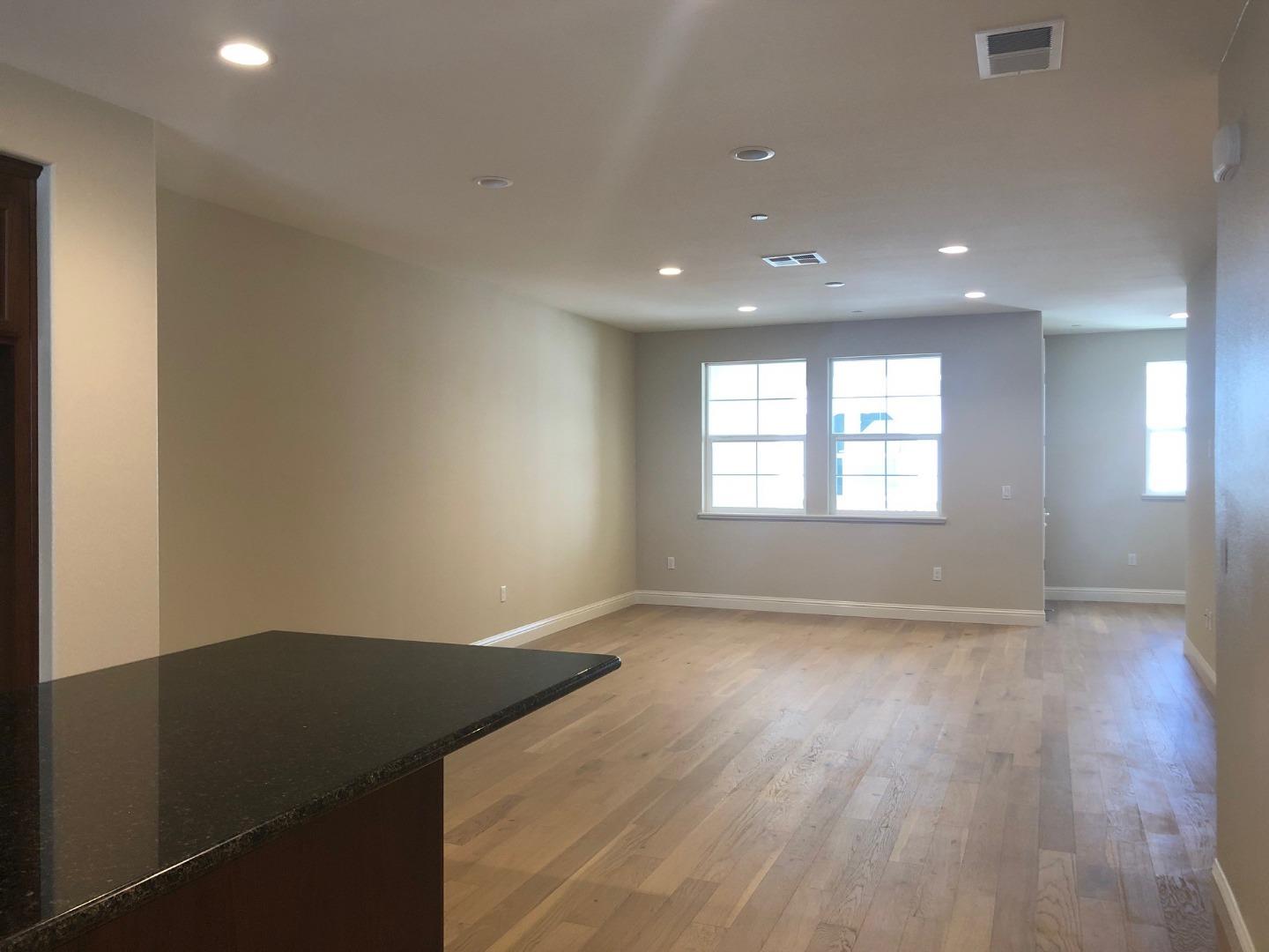 263 Wild Rose Way Milpitas, CA 95035 - Photo 11 of 30 an empty room with wooden floor and windows