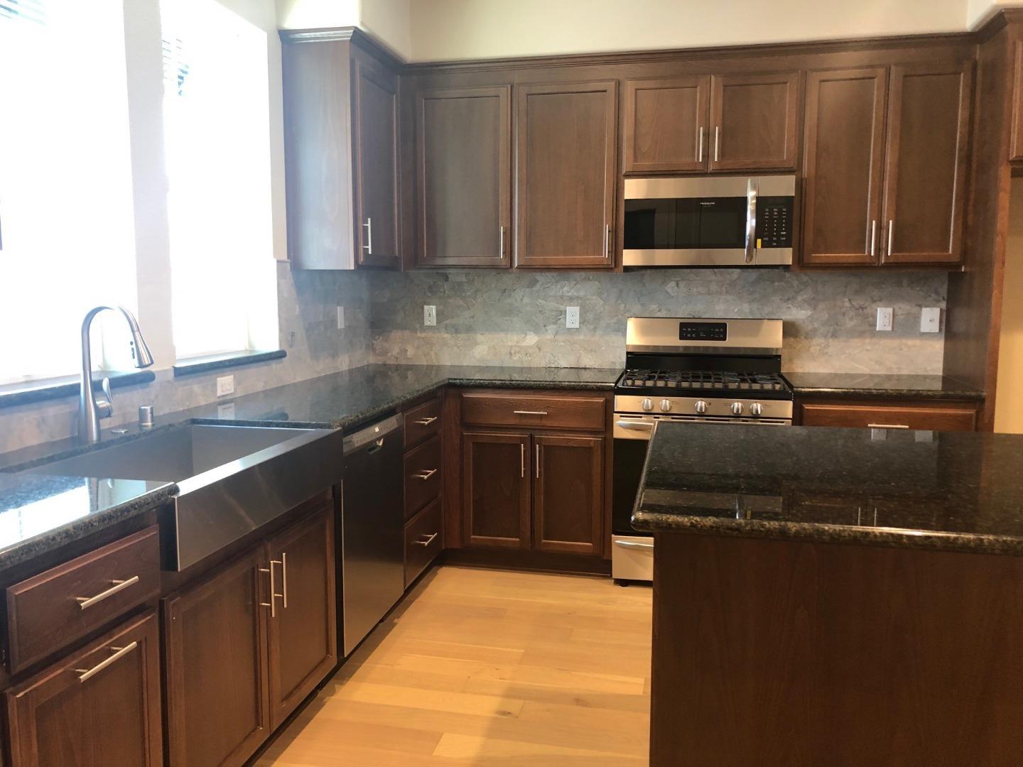 263 Wild Rose Way Milpitas, CA 95035 - Photo 12 of 30 a kitchen with stainless steel appliances granite countertop a stove a sink and a microwave