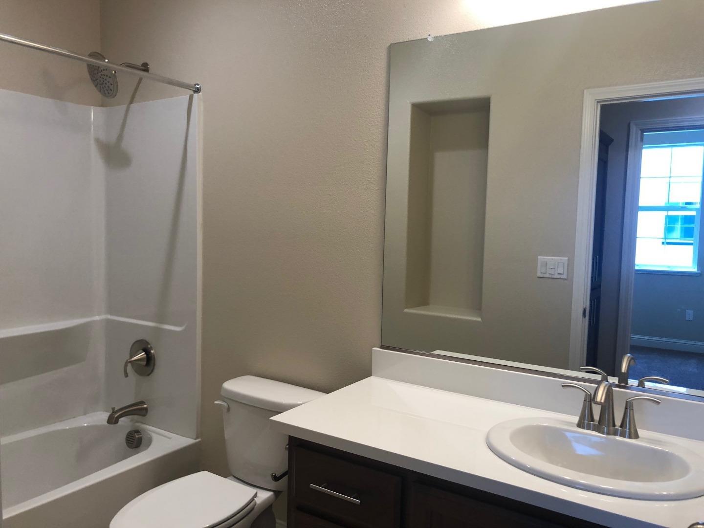 263 Wild Rose Way Milpitas, CA 95035 - Photo 19 of 30 a bathroom with a sink toilet a mirror and shower