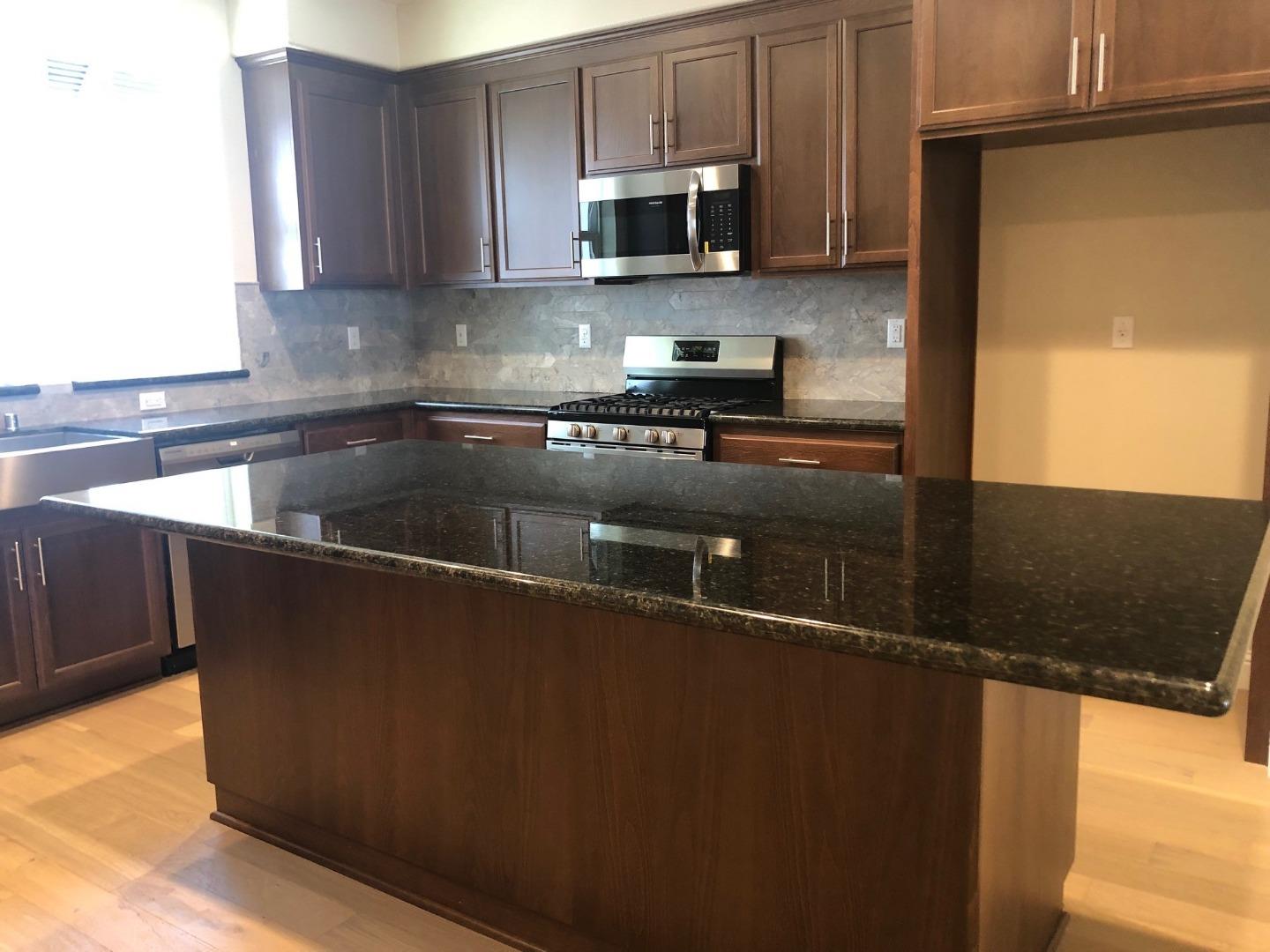 263 Wild Rose Way Milpitas, CA 95035 - Photo 8 of 30 a kitchen with kitchen island a sink a stove and a microwave