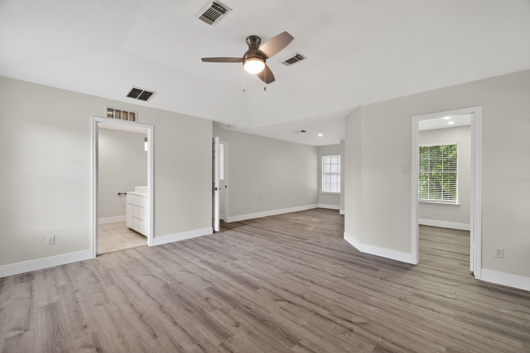 918 Ivycroft Lane Spring, TX 77373 - Photo 21 of 33 a view of an empty room with wooden floor and a ceiling fan