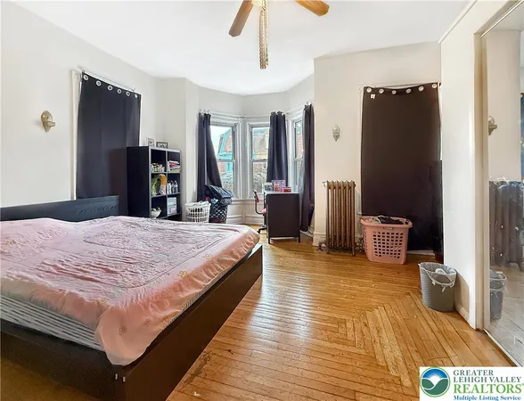 a bed room with a bed and a television