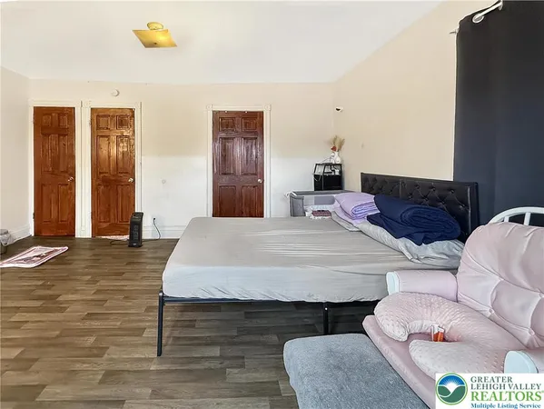 a bedroom with a bed couch and a dresser