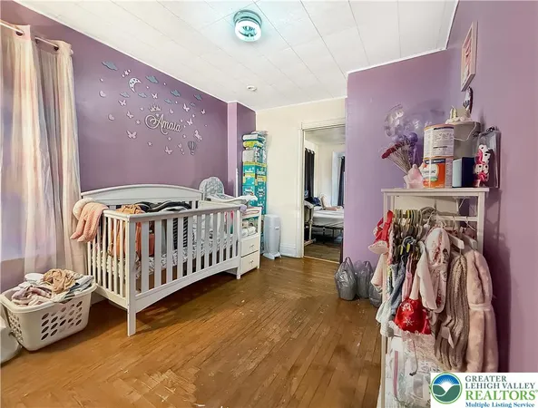 a bedroom with furniture and baby crib