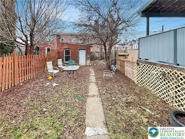 a view of a house with backyard and sitting area